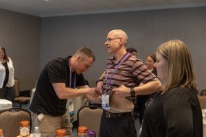Scott Kastning practices measuring waist circumference on Tony Fantozzi