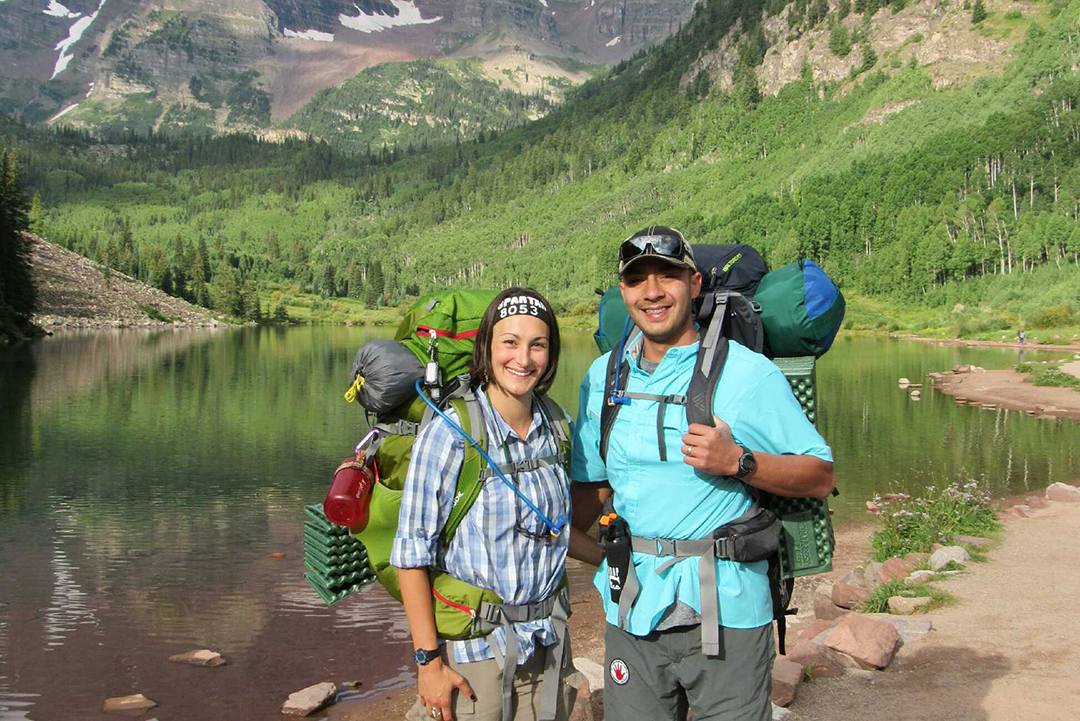 Julie Torres and Joe Torres next to a lake in the mountains