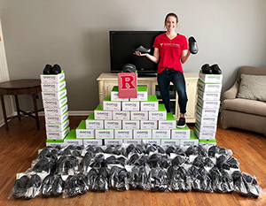 Molly deButts with shoe boxes
